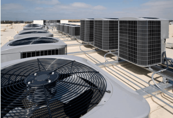 Outdoor HVAC condenser units lined up outside a building