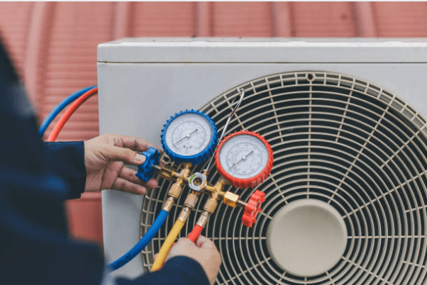 HVAC technician performing maintenance checks on equipment